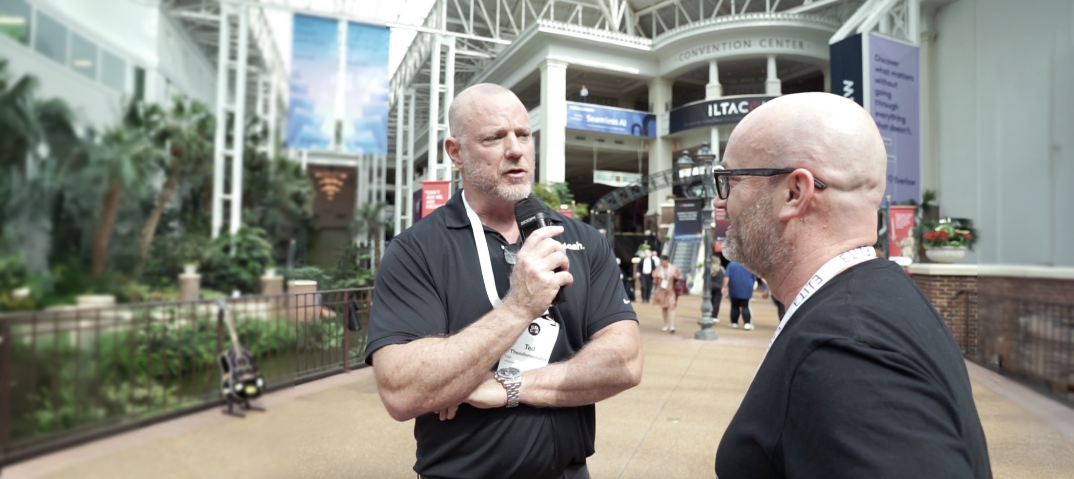 Ted Theodoropoulos interviewing a guest at a legal technology conference